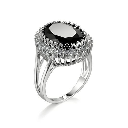 bague obsidienne avec pierre noire ovale facettée entourée de petits oxydes sur monture argentée ajourée avec double anneau