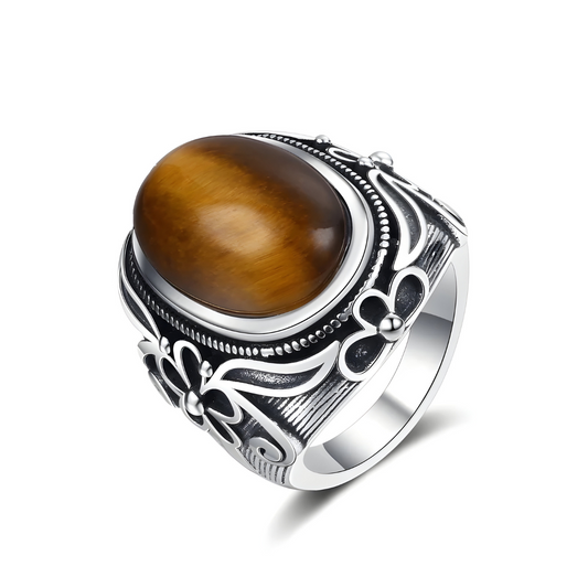 Bague oeil de tigre en argent avec pierre ovale marron doré montée sur un anneau large décoré de motifs floraux et détails en relief foncé