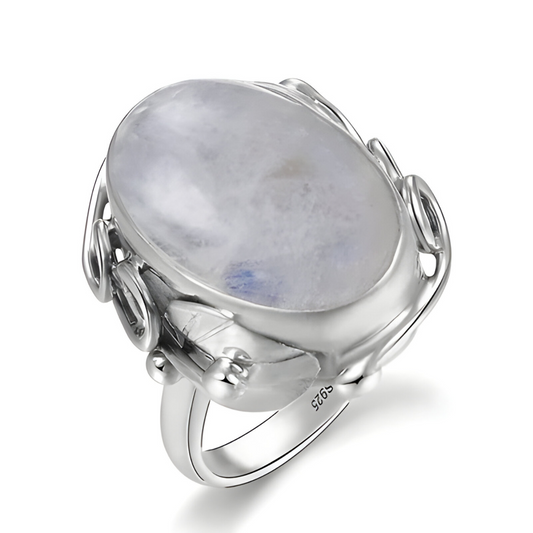 Bague pierre de lune blanche ovale montée sur anneau argenté avec monture filigranée en spirale sur les côtés
