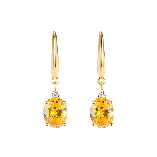 boucles d’oreilles citrine ovales suspendues sur monture dorée avec petites pierres blanches rondes serties au-dessus