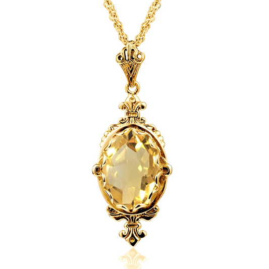 Une chaîne fine dorée porte un pendentif ovale en citrine facettée serti dans un décor filigrane, collier Citrine orné de motifs floraux