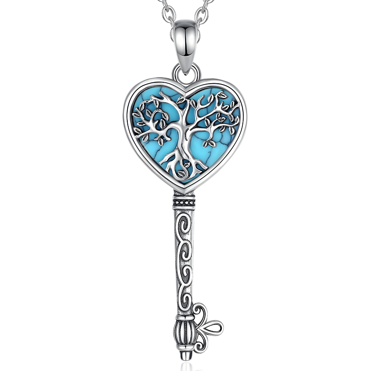 Un Collier Turquoise Argent en forme de clé, orné d’un pendentif cœur turquoise et d’un arbre de vie finement ciselé